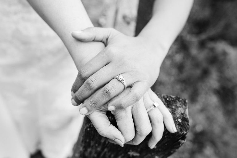 black and white image of women holding hands before same sex LGBT wedding in New Hope PA