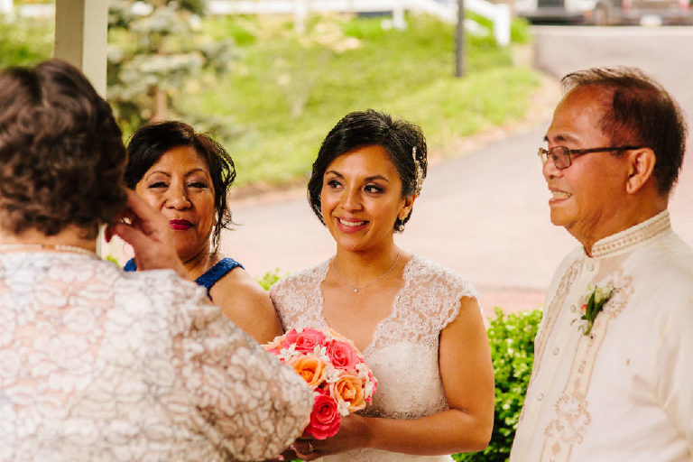 beautiful Filipina Pinoy bride smiles with her parents before a wedding at 1740 House outside New Hope PA