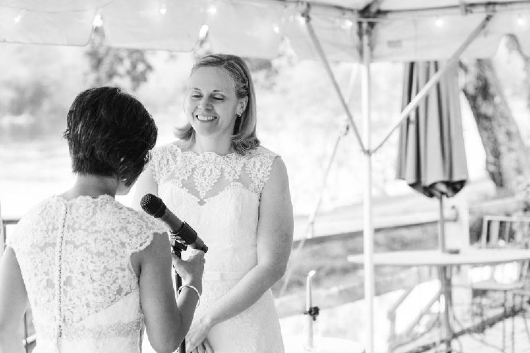 bride laughs at small intimate wedding overlooking the Delaware River outside New Hope Pennsylvania