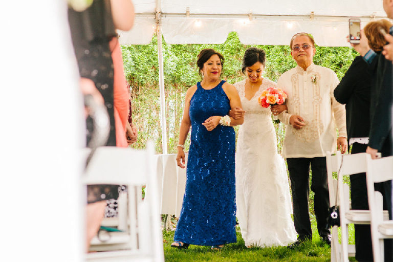 Filipina bride walks her parents down the aisle at an intimate garden wedding by the Delaware River