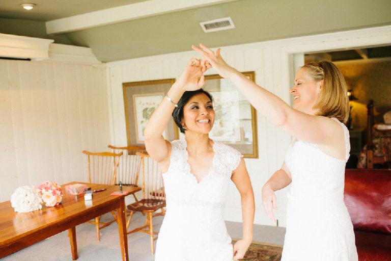 two young lesbian brides practice dancing in their room at the 1740 House before their same sex wedding by Kasey Ivan Photography