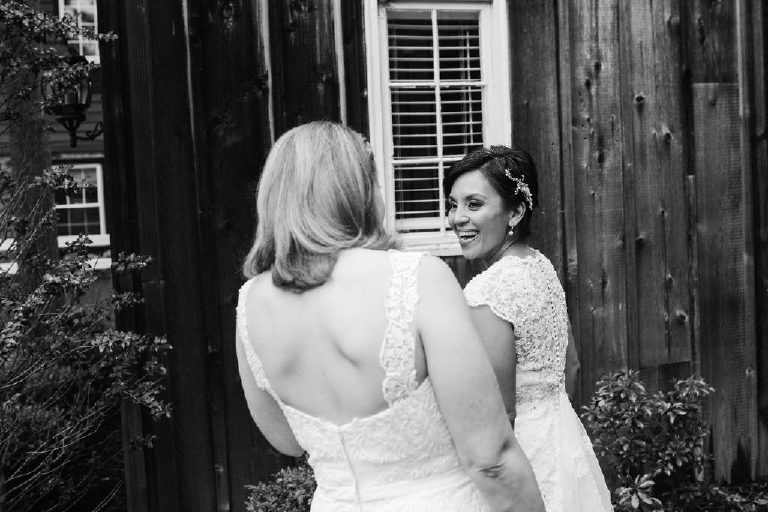 same sex brides see each other for first look outside 1740 House in New Hope PA before wedding