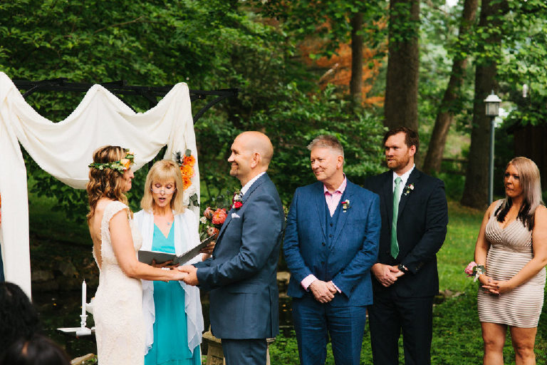 bride and groom at summer wedding ceremony in the woods at Black Bass Hotel outside New Hope Pennsylvania by Kasey Ivan Photography
