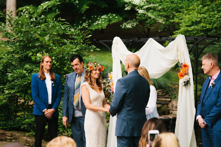 bride and groom at summer wedding ceremony in the woods at Black Bass Hotel outside New Hope Pennsylvania by Kasey Ivan Photography
