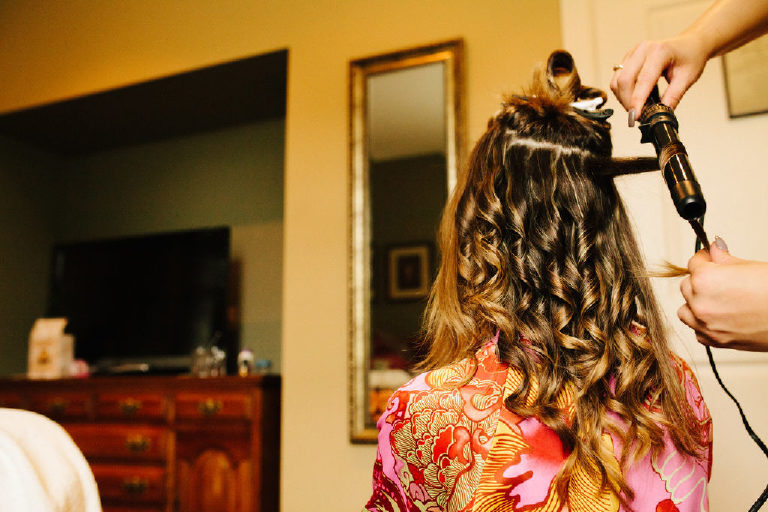 bride getting her hair curled before a wedding outside New Hope, Pennsylvania
