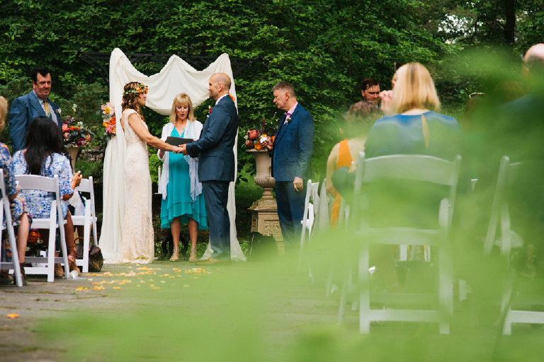 bride and groom at summer wedding ceremony in the woods at Black Bass Hotel outside New Hope Pennsylvania by Kasey Ivan Photography