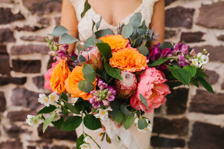 bride holding a bouquet of summer flowers by Lauren Kiernan from Flora in Lambertville, NJ