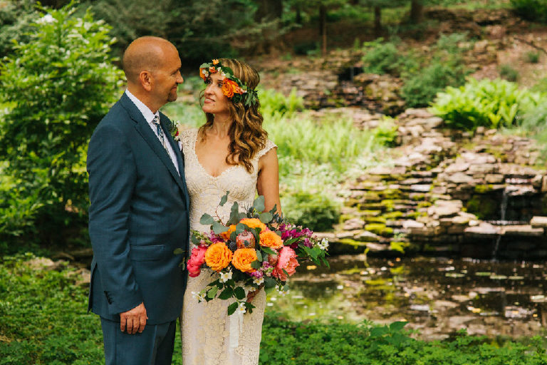 bride and groom pose for summer wedding portraits in the woods by Kasey Ivan Photography outside the Black Bass Hotel near New Hope PA