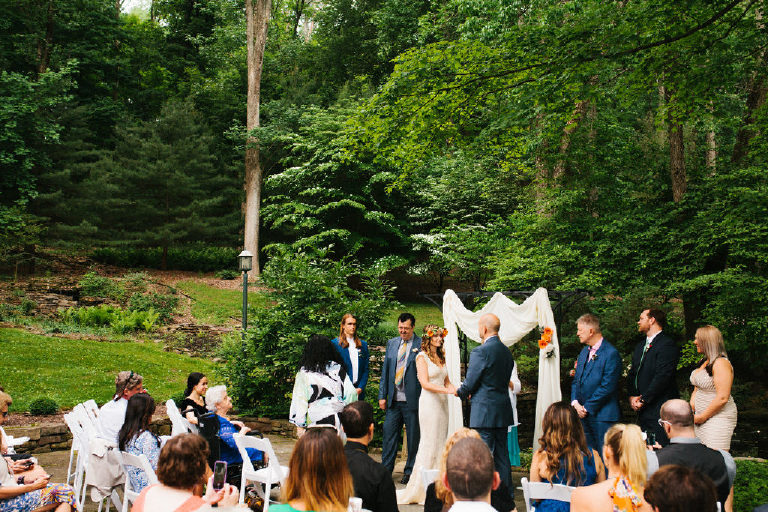 bride and groom at summer wedding ceremony in the woods at Black Bass Hotel outside New Hope Pennsylvania by Kasey Ivan Photography