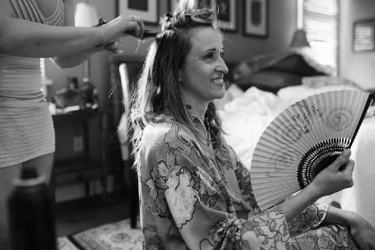 Katia the bride fans herself with a paper fan while wearing a kimono before her wedding at the Black Bass Hotel