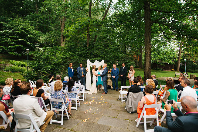 bride and groom at summer wedding ceremony in the woods at Black Bass Hotel outside New Hope Pennsylvania by Kasey Ivan Photography