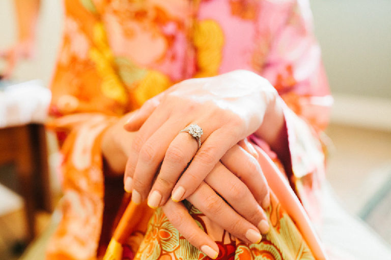 Close up of the engagement ring on brides hands