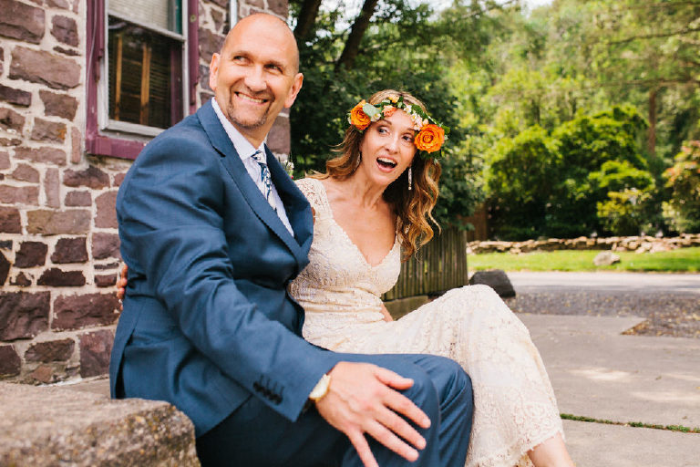 bride and groom look excited at Delaware River for wedding photos outside Black Bass Hotel 