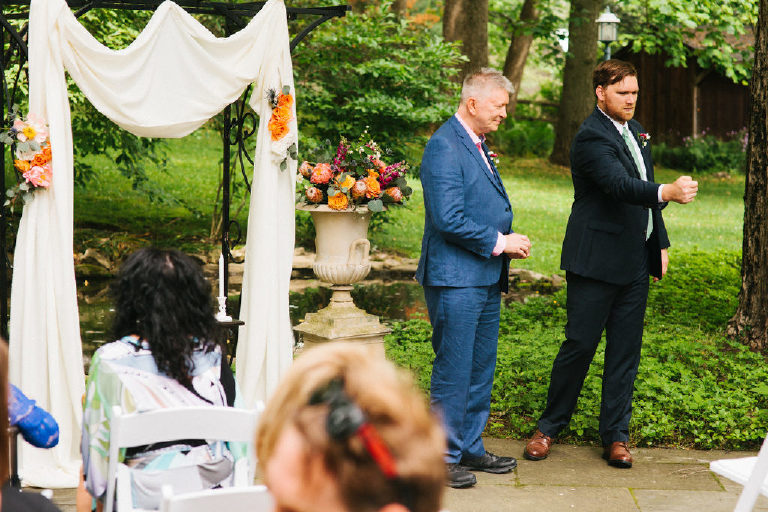 groomsmen await for the couple to arrive at an Italian summer wedding at the Black Bass Hotel outside New Hope PA