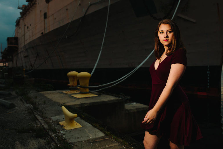 Senior girl walking in the navy shipyard posing for Kasey Ivan Photography
