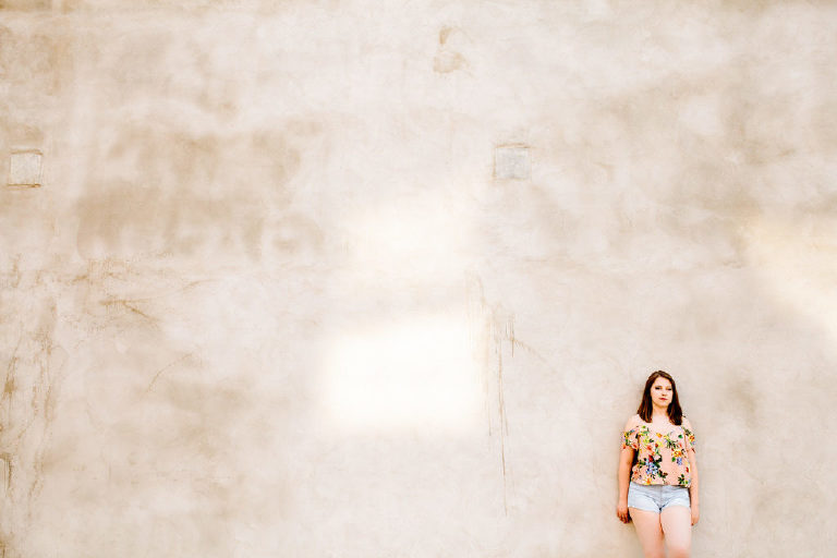 Senior girl leaning against a wall thinking in old city Philadelphia
