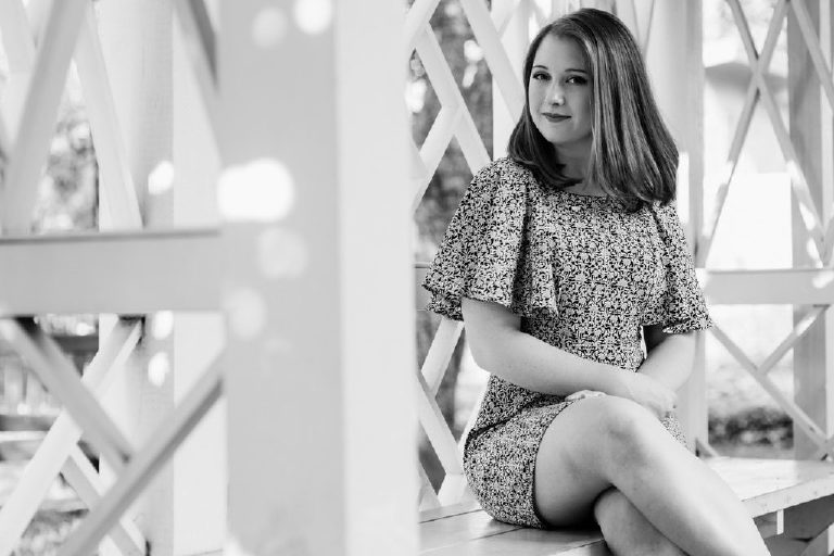 Clara sitting on a bench in a park in Philadelphia