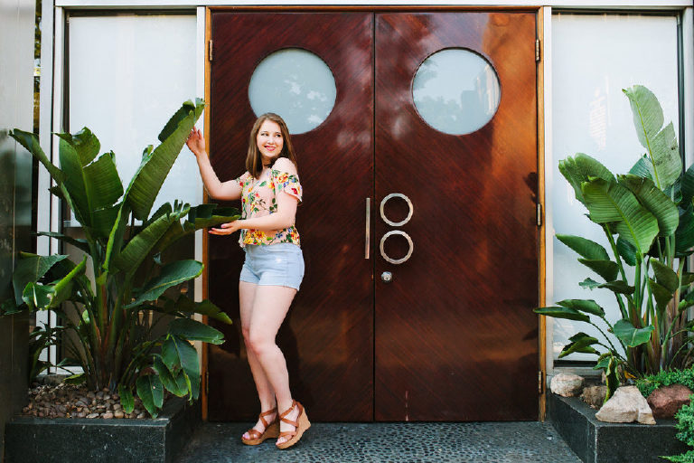 Girl infront of a resturant in old city Philadelphia posing for a decorative plant