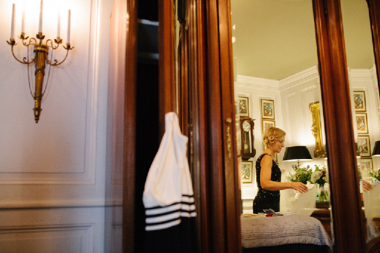 Picture taken through a mirror of a women getting ready for a rustic wedding at porches on the Towpath in New Hope PA