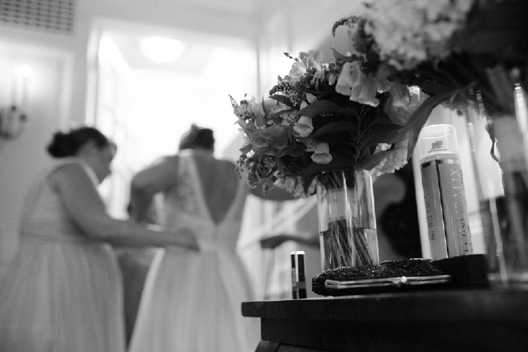 Picture of a mother helping her daughter get ready for her wedding fixing her wedding dress at New Hope and Lambertville