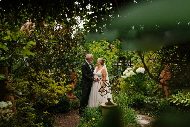 Bride and groom standing in a garden in the porches on the towpath wedding photography by Kasey Ivan 