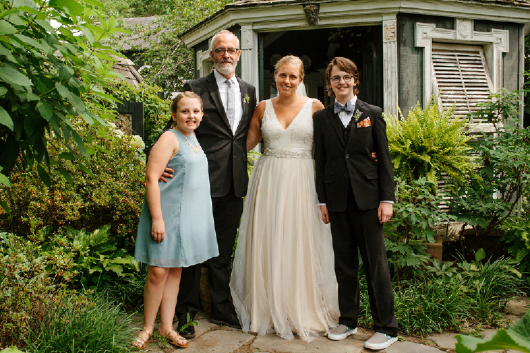 Picture of the bride and groom with their children in a garden of the porches in the towpath in New Hope and Lambertville