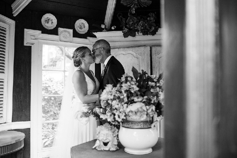 Black and white photography of a future wife and husband kissing in a chic room at the Porches on the Towpath in New Hope and Lambertville