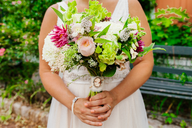 Photograph of a women holding a colorful and chic bouquet of flowers at the Porches on the Towpath in New Hope and Lambertville