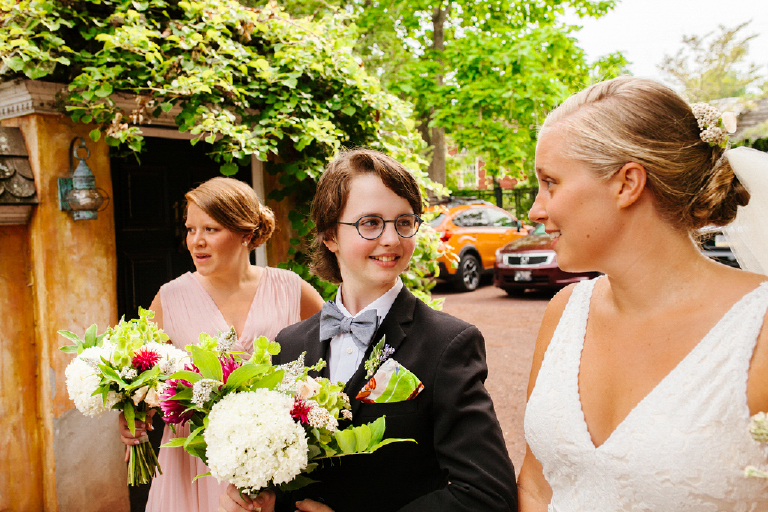 Photograph of a bride looking at her daughter holding flowers at the Porches on the Towpath in New Hope and Lambertville