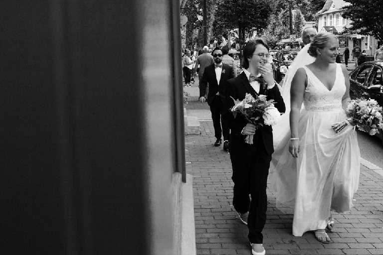 Black and white photo of a bride walking with her daughter to her wedding in the Porches on the Towpath in New Hope and Lambertville