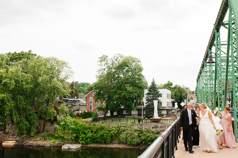 Picture of a groom and bride walking across the New Hope and Lambertville bridge across the delaware river