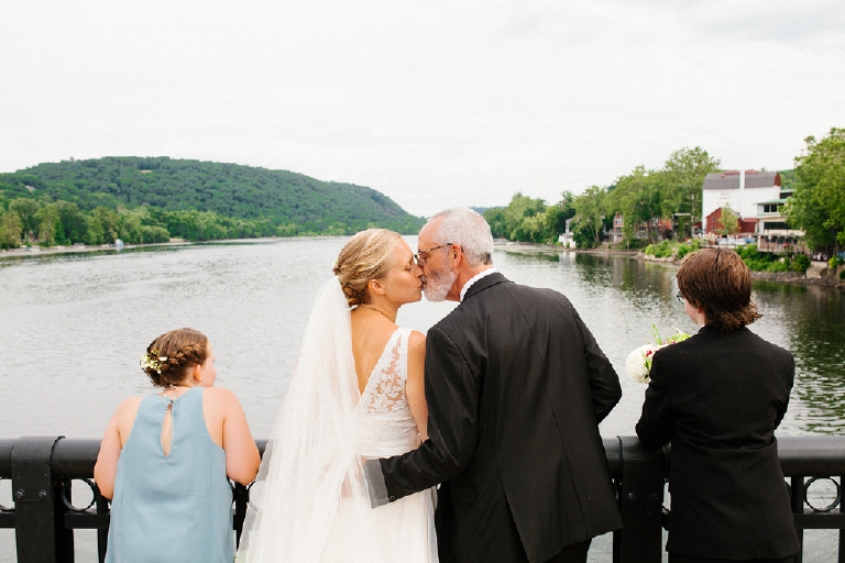 Husband and wife kissing on the New Hope and Lambertville bridge