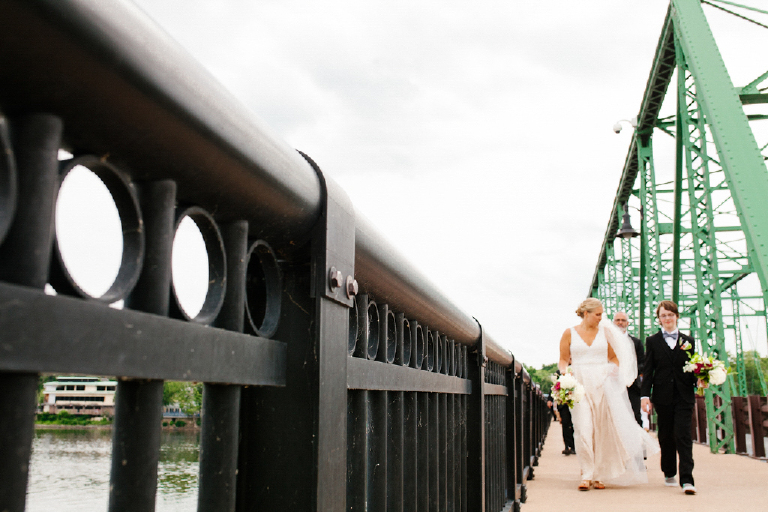Bride walking with her daughter across the New Hope and Lambertville bridge