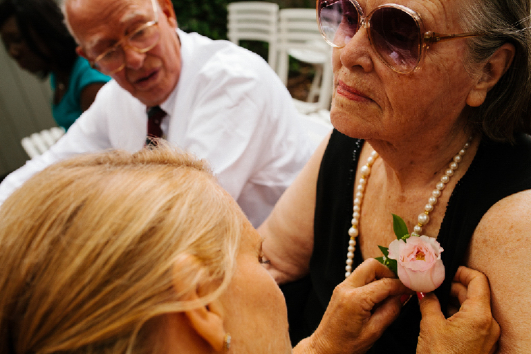 Picture of a women pinning a flower on a grandmas dress for a wedding at Hamiltons Grill Room Lambertville