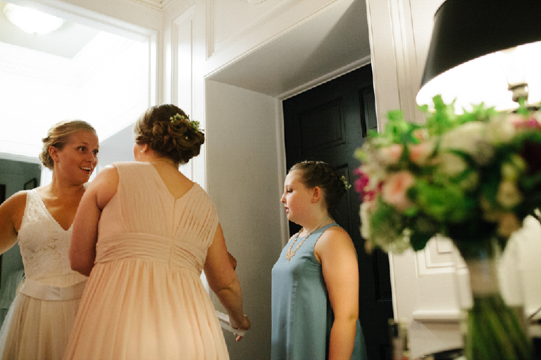 Girls standing together talking with the bride of a rustic wedding in Porches on the towpath in New Hope