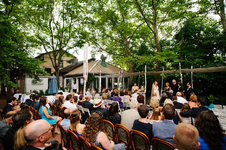 Photograph of all wedding guest sitting outside at a rustic wedding Hamilton's Grillroom Lambertville New Hope