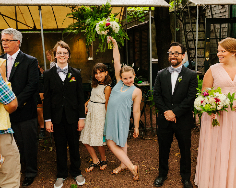 Bride and grooms daughter holding a coorful chic bouquet of flowers and striking a pose Hamilton's Grillroom Lambertville New Hope