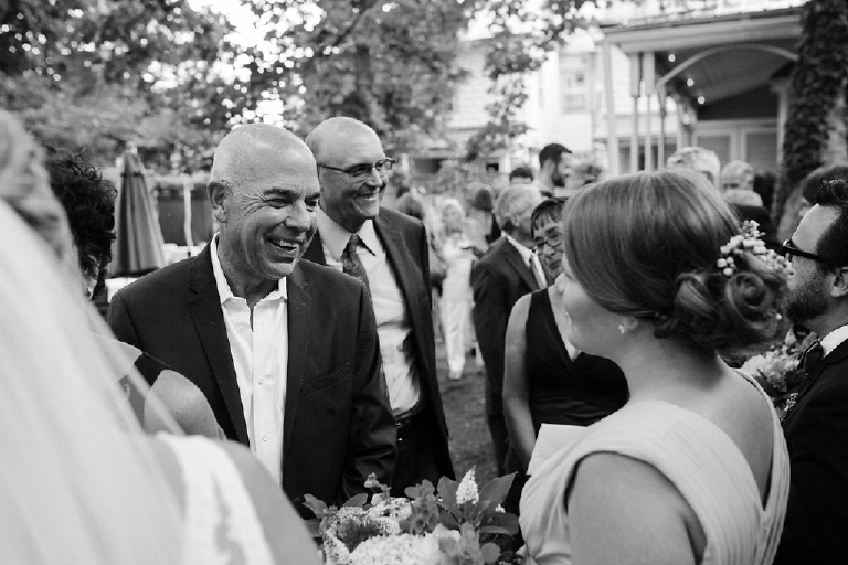 Black and white image of family members talking after a wedding ceremony Hamilton's Grillroom Lambertville New Hope