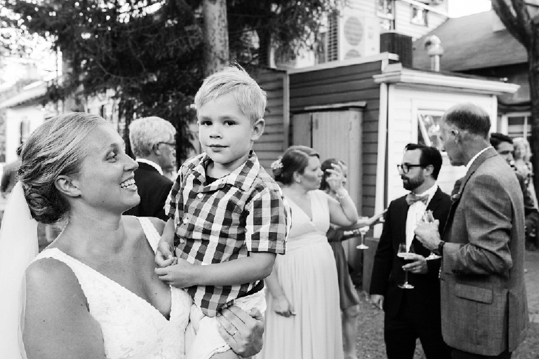 Bride at wedding holding young family memeber in plaid at Hamilton's Grillroom Lambertville New Hope