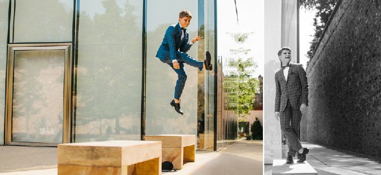 high school senior jumps in the air and for rock and roll inspired GQ photo shoot of senior pictures outside Doylestown Michener Museum by photographer Kasey Ivan