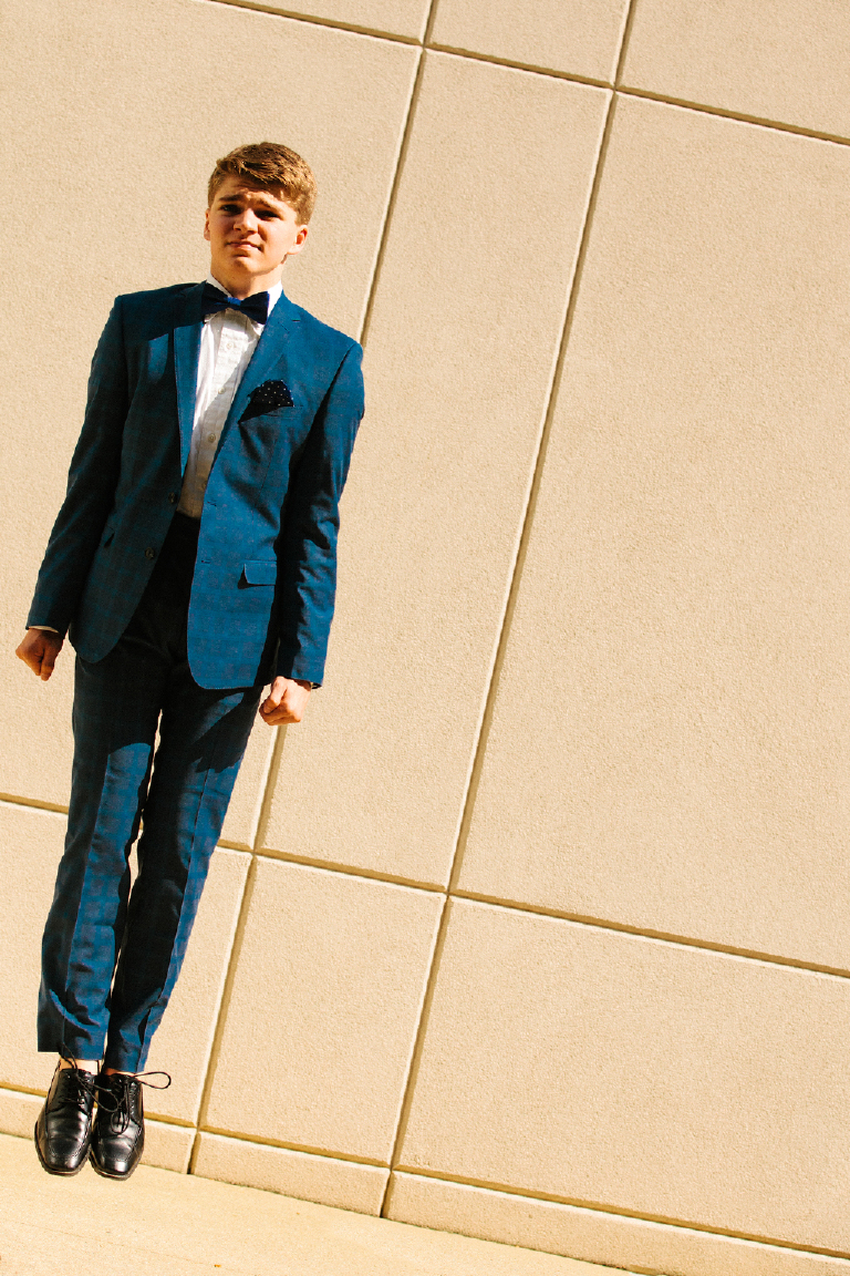 Tyler McClellan in blue suit floating jumping at unique geometric angle