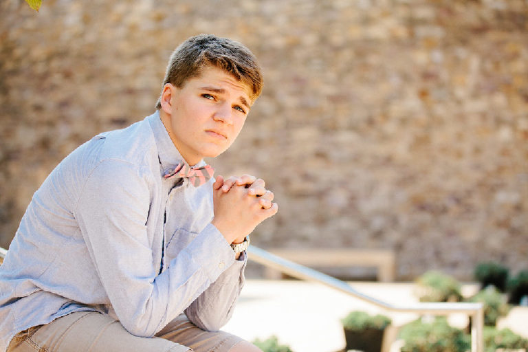 Tyler McClellan senior holds hands in pink bowtie at Michener Museum in Doylestown Pennsylvania by photographer Kasey Ivan Photography-16