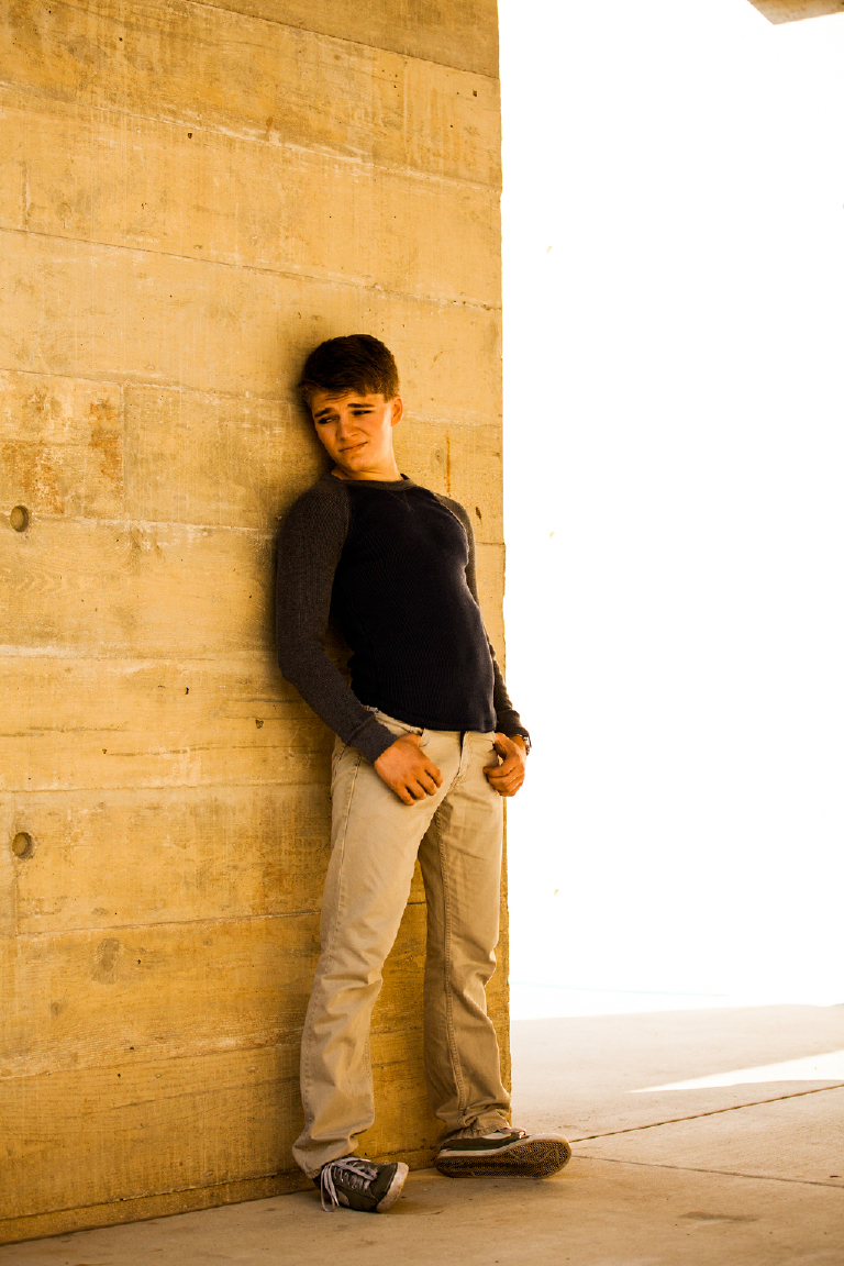 high school senior boy poses outside Mercer Museum in Doylestown Pennsylvania for senior pictures by photographer Kasey Ivan Photography