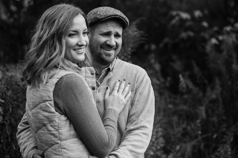 mother and father look at their kids for family portrait by New Hope photographer Kasey Ivan