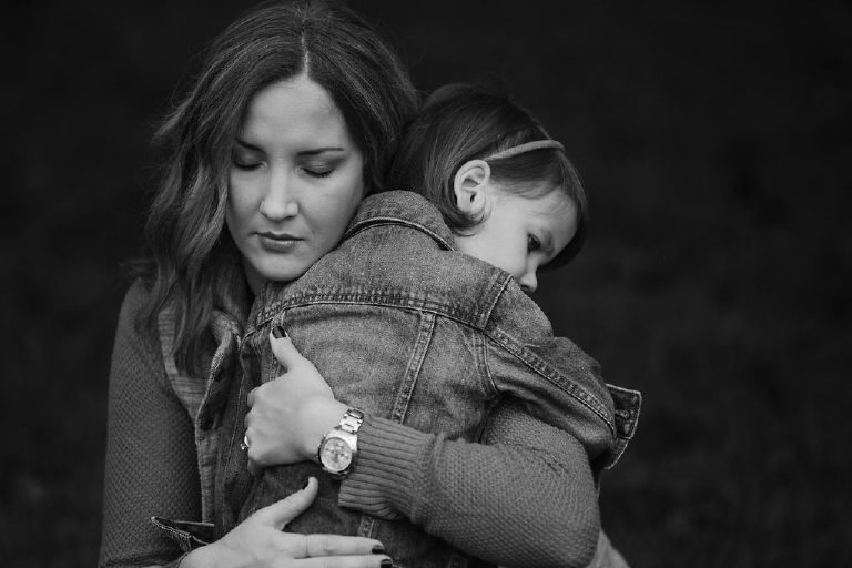 black and white mother hugging daughter for family portrait by New Hope photographer Kasey Ivan