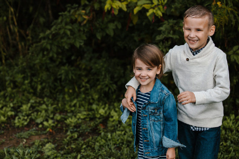brother sister smiling together for family portrait by New Hope photographer Kasey Ivan