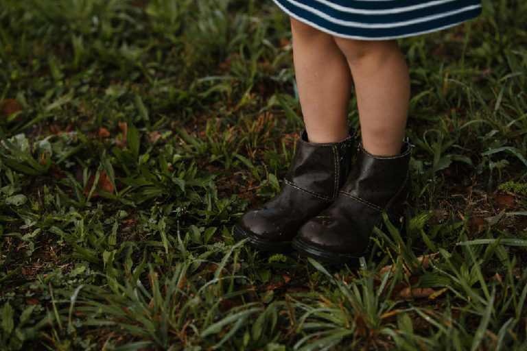little girl boots wet in the dew and grass