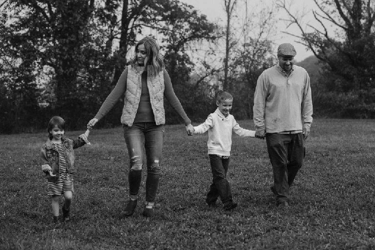 family walking hand in hand for family portrait by New Hope photographer Kasey Ivan