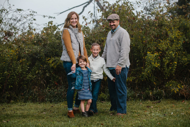 family all together standing by bushes for family portrait by New Hope photographer Kasey Ivan