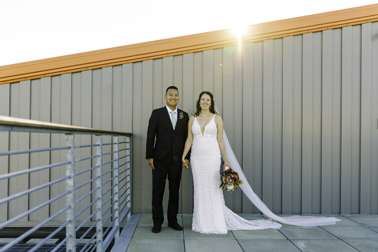 Couple holding hands at the iconic rooftop bar at Bayside Bowl in Portland Maine